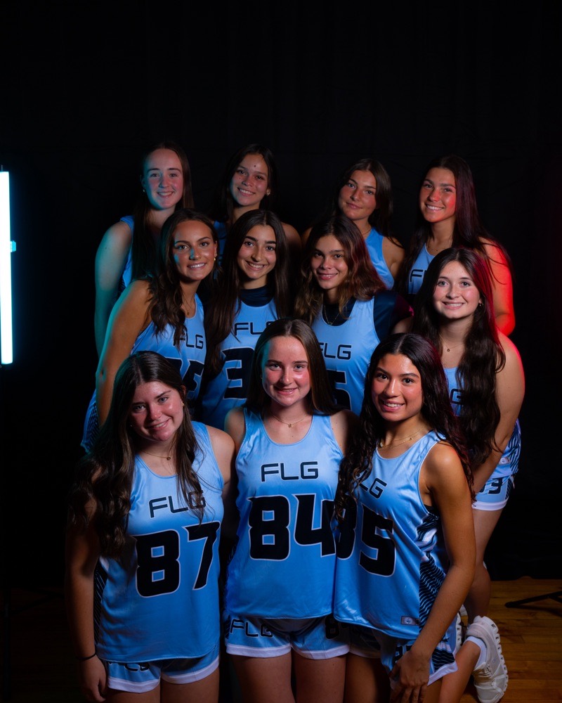 An FLG high school team grouped together in Carolina blue uniforms.